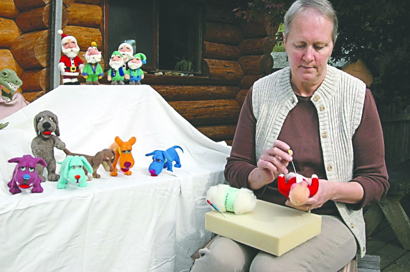 Needle felter Janet Watral crafts a Santa as part of a “Night Before Christmas” basket raffle for the PEO Bazaar scheduled Saturday. Greg Thomas