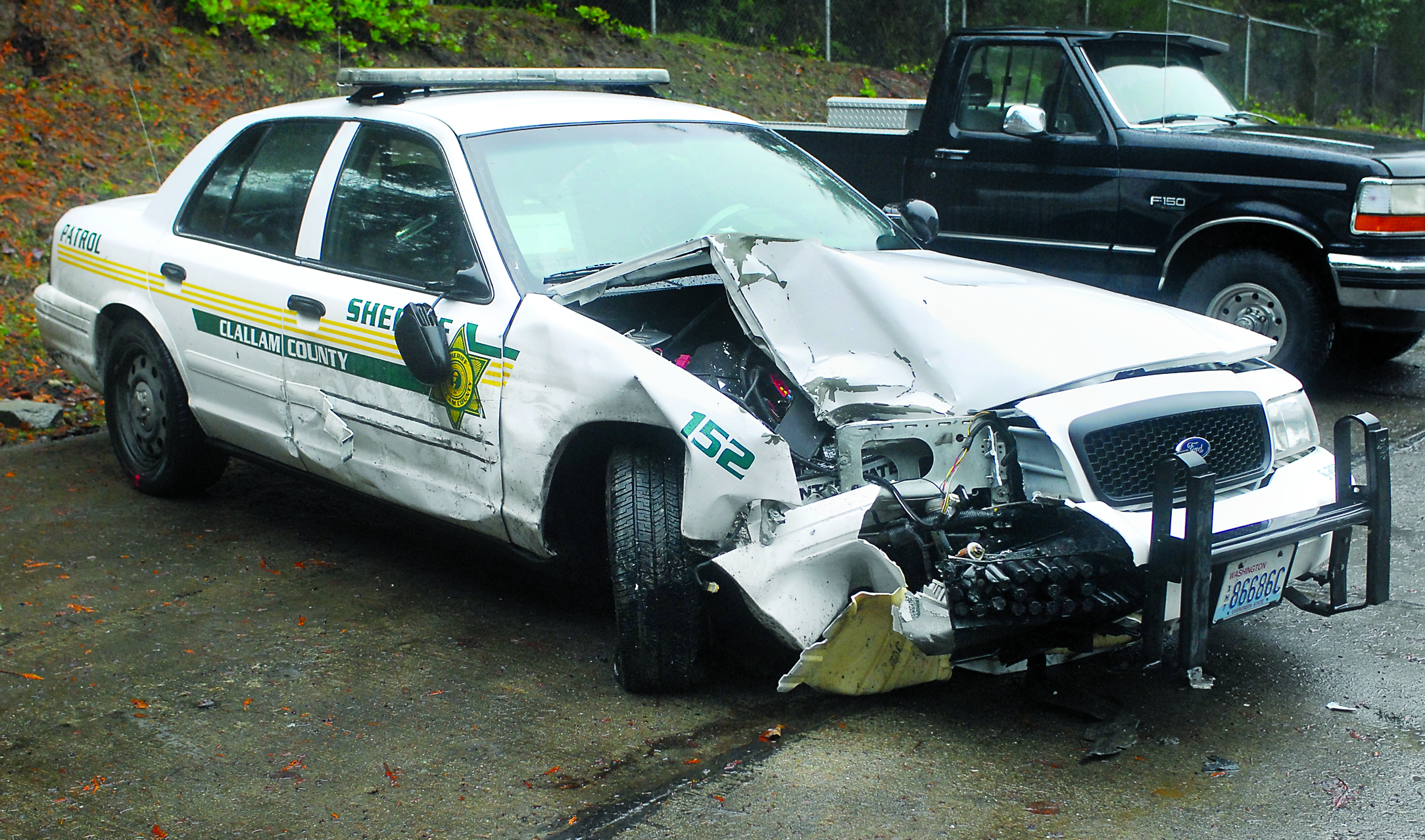 A damaged Clallam County Sheriff's Office patrol car sits at the Clallam County Shop Yard in Port Angeles on Wednesday after it was involved in a wreck on Wednesday morning. Keith Thorpe/Peninsula Daily News