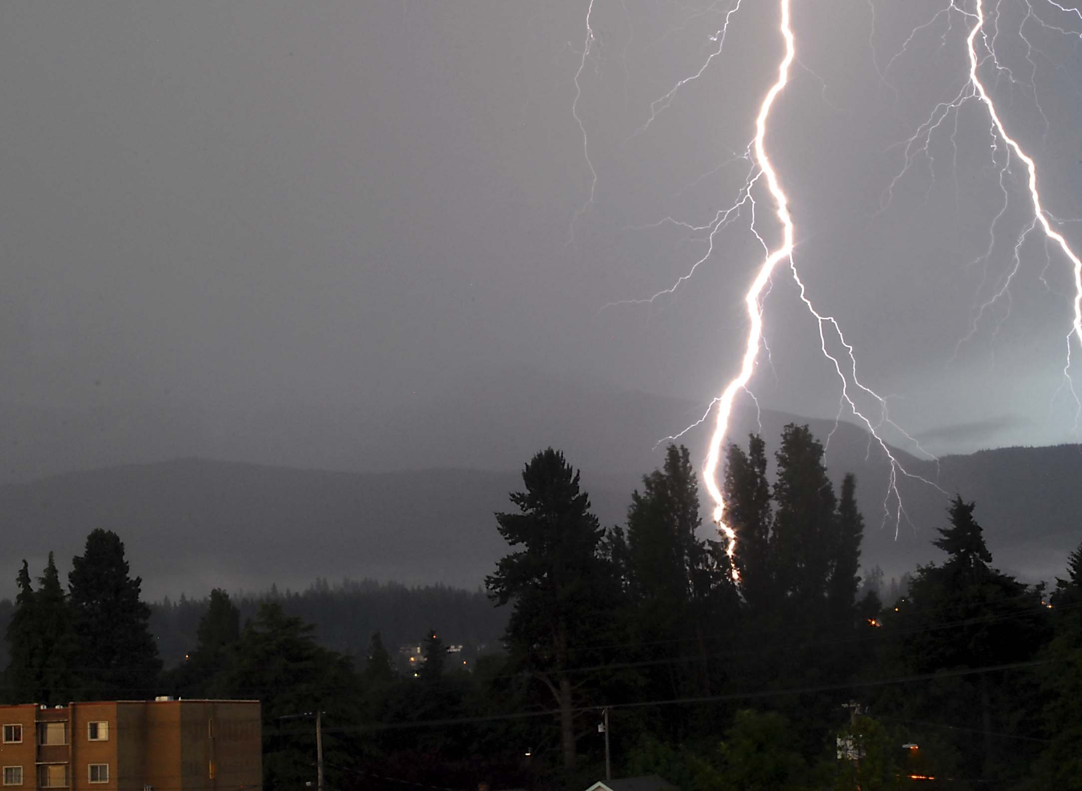 A bolt of lightning hits above the Peabody Heights section of Port Angeles near Port Angeles High School about 5:30 a.m. today. Keith Thorpe/Peninsula Daily News