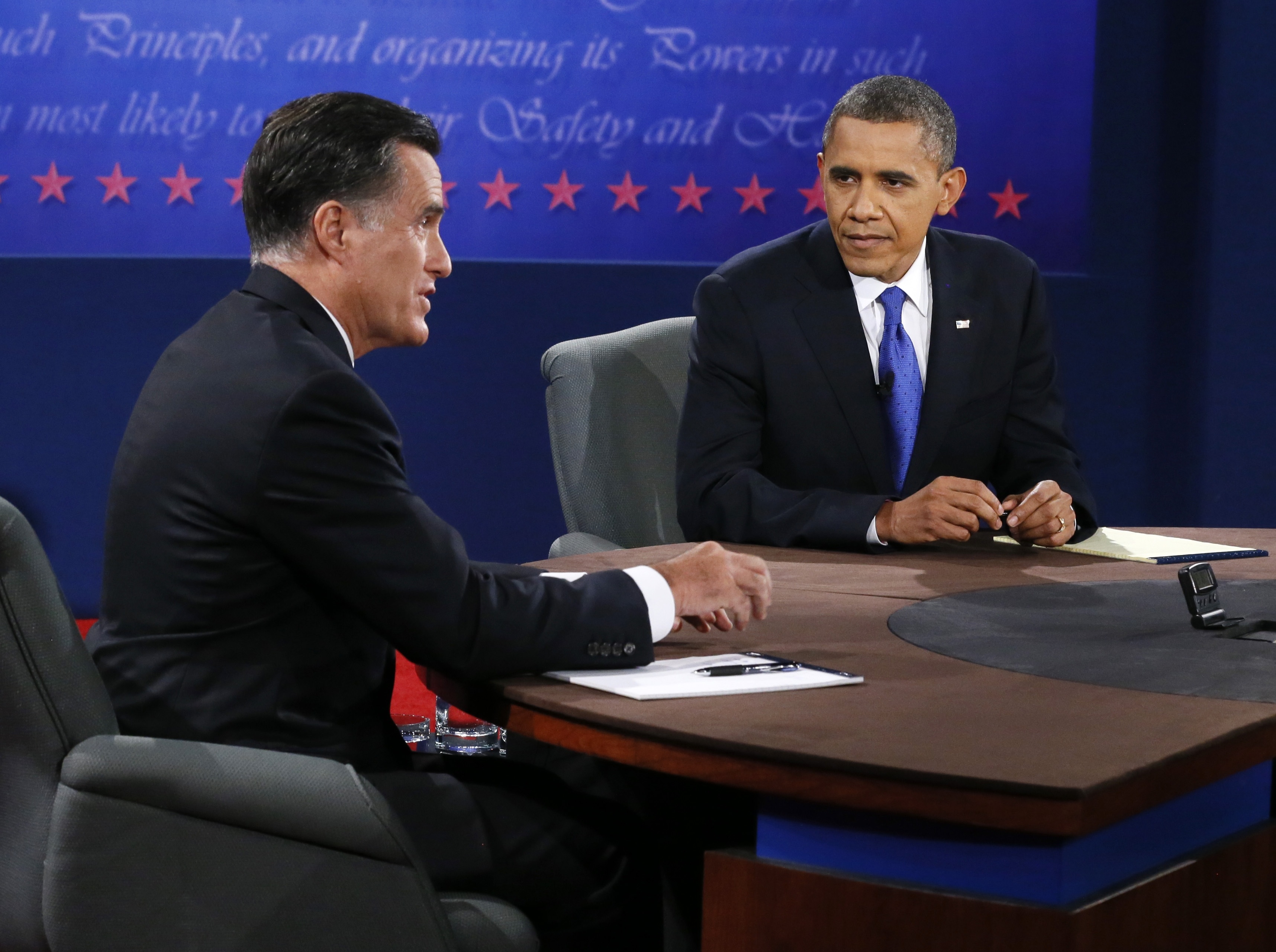 Mitt Romney makes a point as President Obama listens during Monday night's presidential debate. The Associated Press