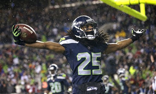 Seattle Seahawks' Richard Sherman motions to fans after intercepting in the end zone against the San Francisco 49ers in the second half of Sunday's rout of the 49ers. Elaine Thompson/The Associated Press