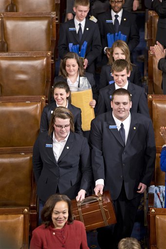 Senate pages arrive in the House chamber on Capitol Hill carrying sealed certificates to be announced by the Electoral College during a joint session of Congress. The Associated Press