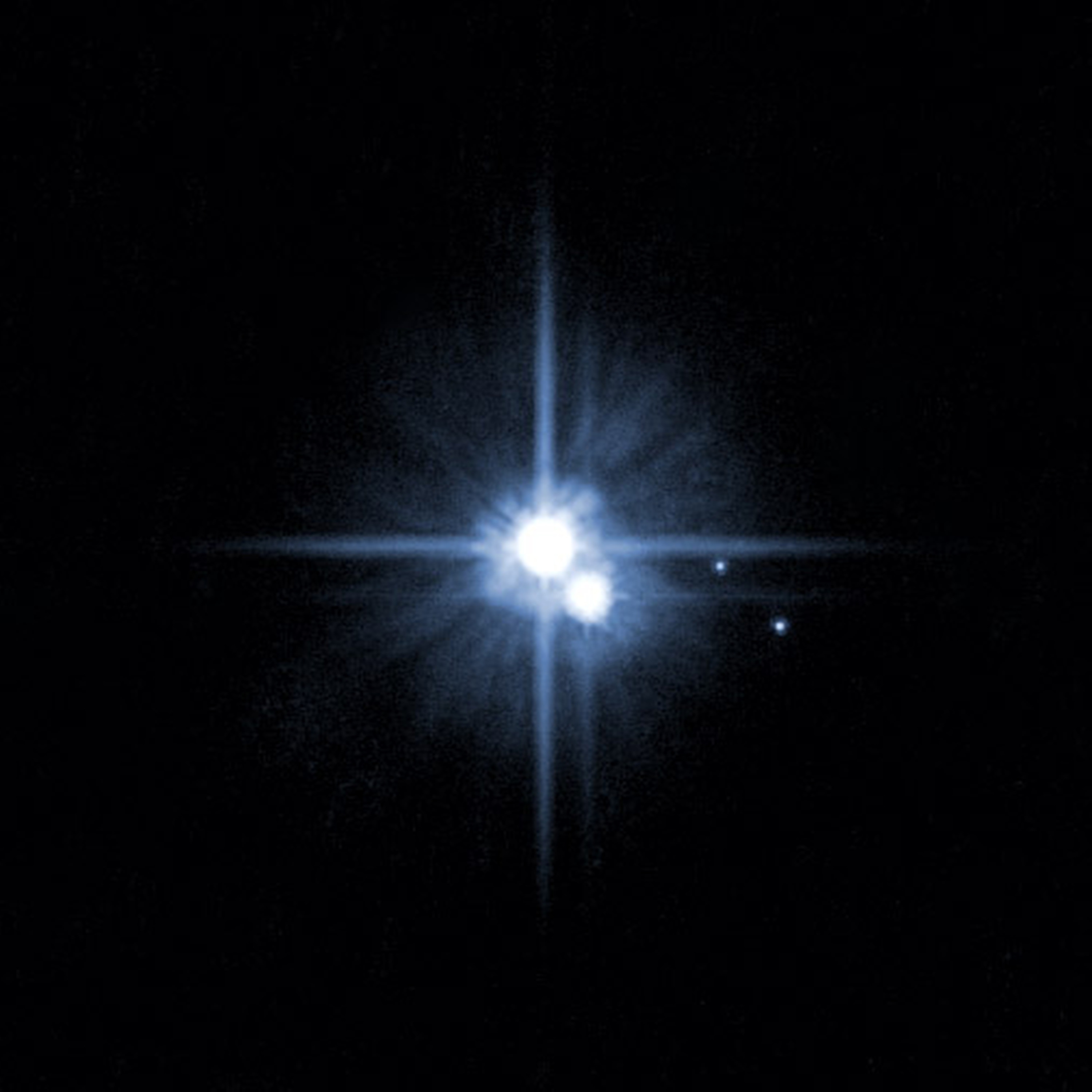 Pluto and three of its five moons