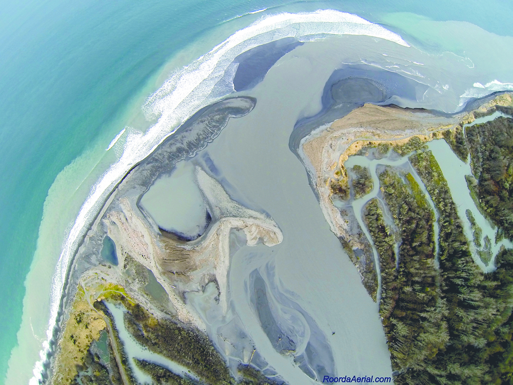 Elwha River sediment is forming sandy beaches at the mouth. The plume of sediment is about 3 feet deep