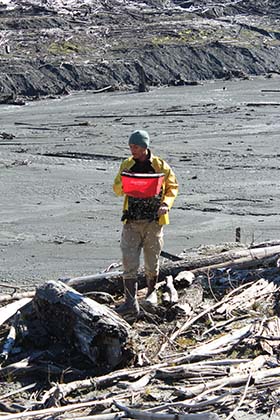 Volunteer Aaron Velasquez disperses some of the 1