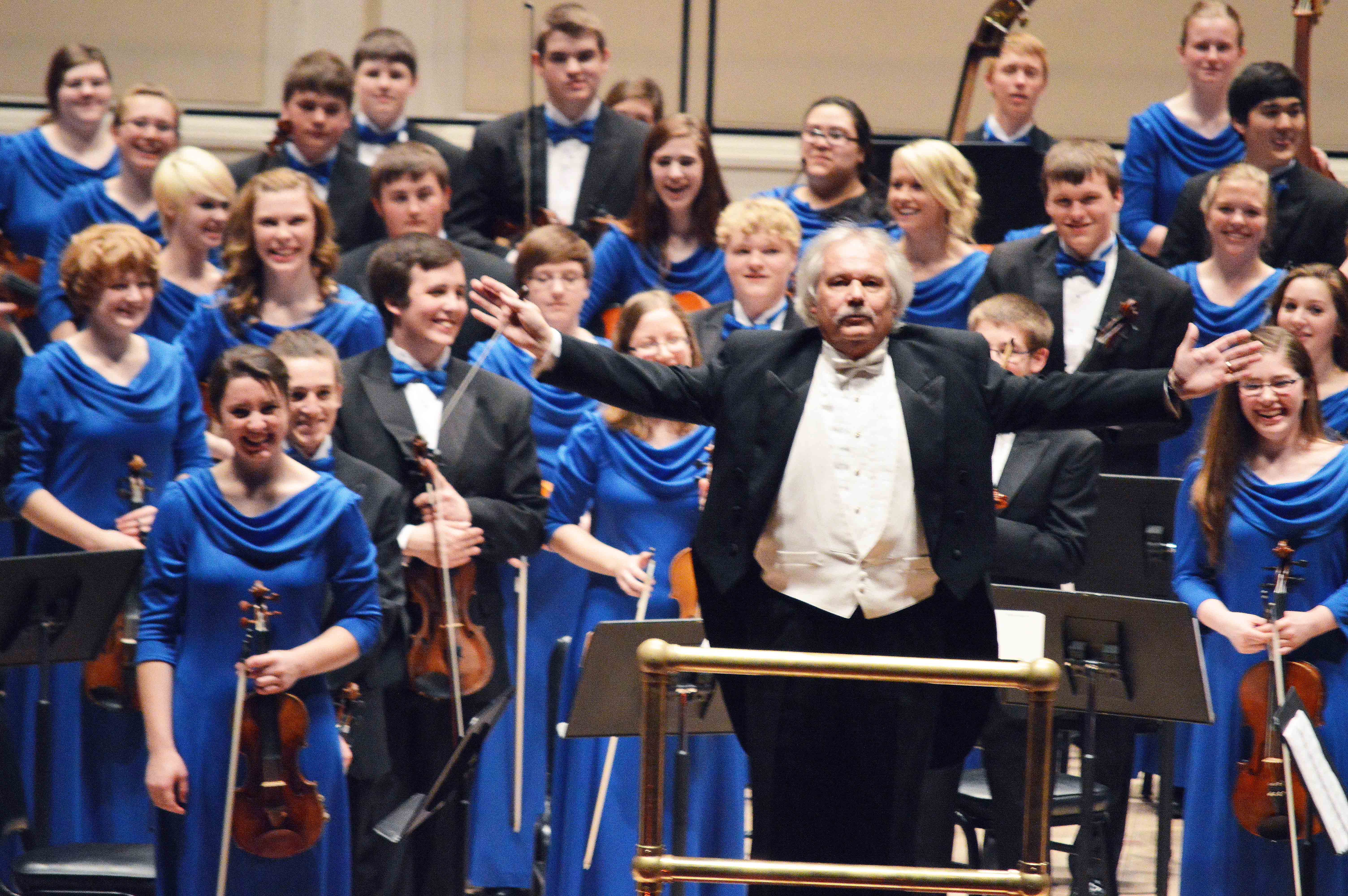 Port Angeles High School Roughrider Orchestra conductor Ron Jones acknowledges the applause following today's performance with 110 young musicians at Carnegie Hall. Diane Urbani de la Paz/Peninsula Daily News