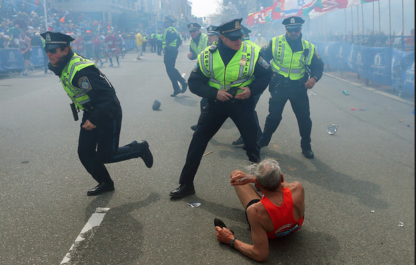 Police officers ran onto the course moments after the first explosion. The Associated Press