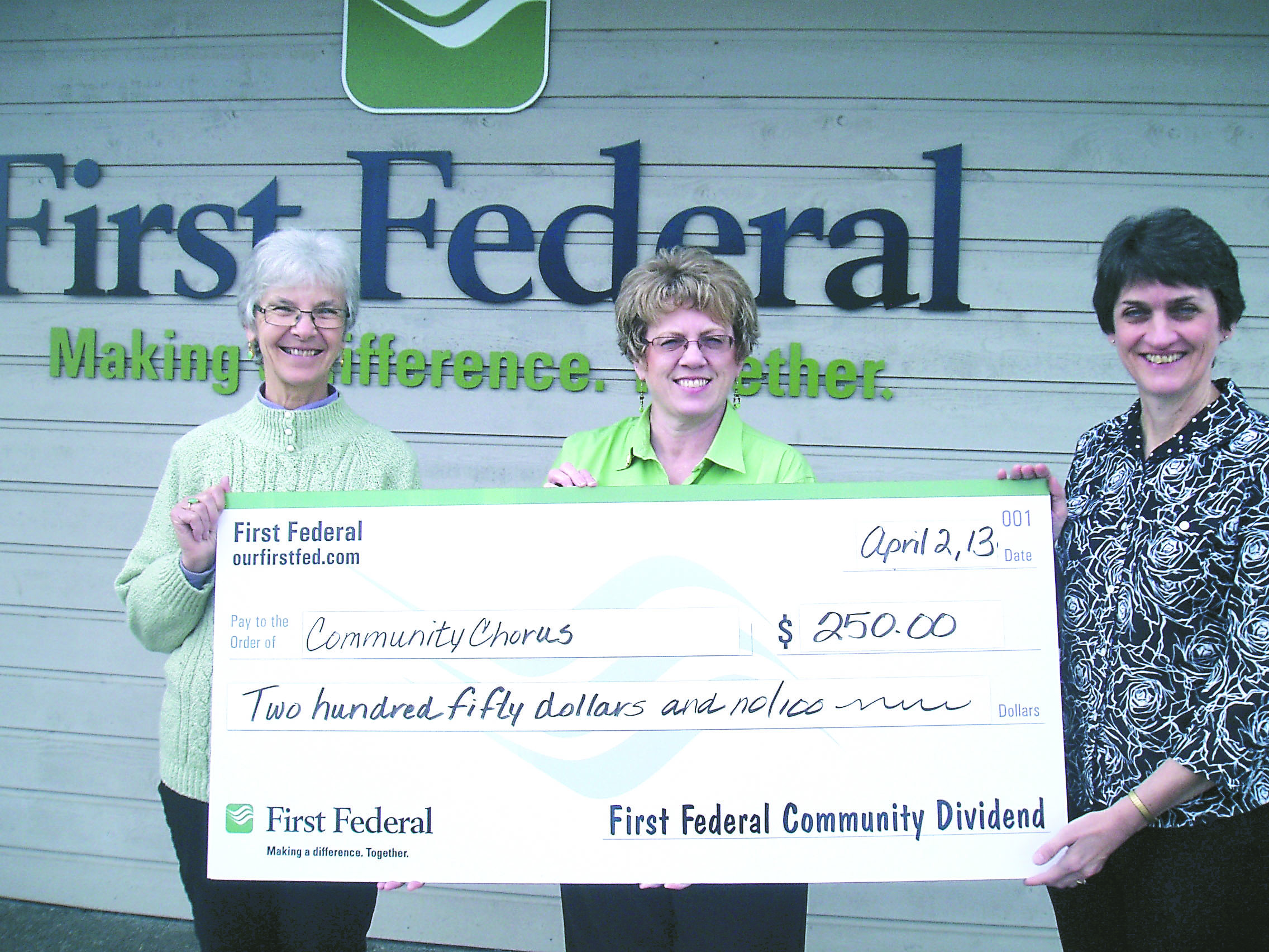 Port Townsend/East Jefferson Community Chorus president Pam McCollum Clise (left) and chorus director Leslie Lewis (right) accept a $250 donation from First Federal's Port Townsend branch manager Laurie Liske.