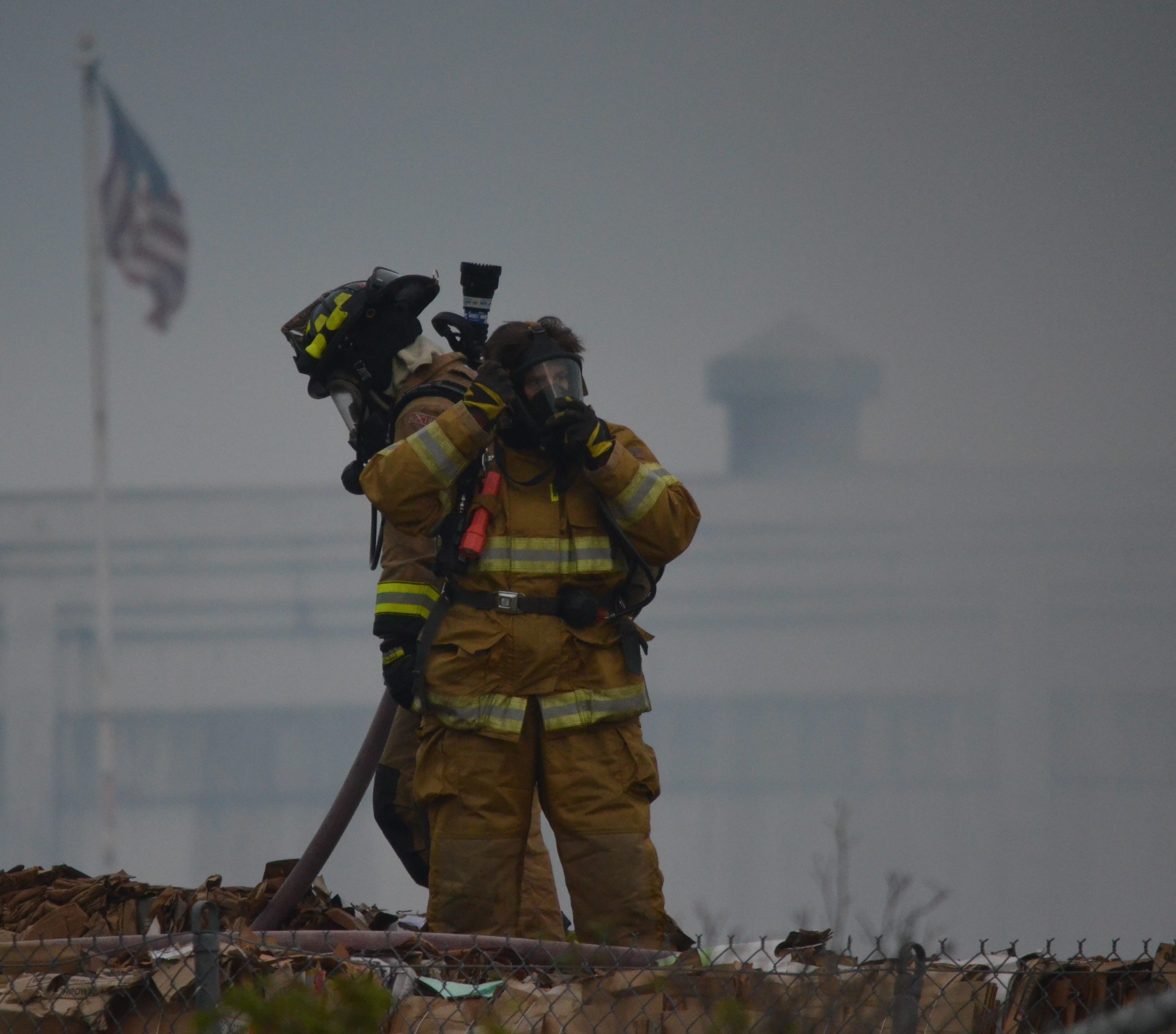 Firefighters work to extinguish a fire in the recycling area at the Port Townsend Paper Corp. mill on Thursday evening. One mill employee was treated for smoke inhalation. Charlie Bermant/Peninsula Daily News