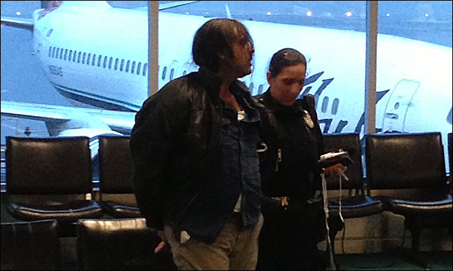 This photo shows Alexander Herrera in custody after Alaska Airlines flight 132 landed safely in Portland. (Courtesy: Ryan Oelrich) KOMO-TV