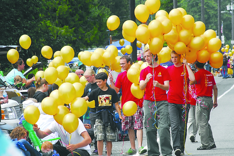 A contingent from Joyce Bible Church passes out balloons to spectators at the Joyce Daze Wild Blackberry Festival grand parade Saturday in Joyce. Keith Thorpe/Peninsula Daily News