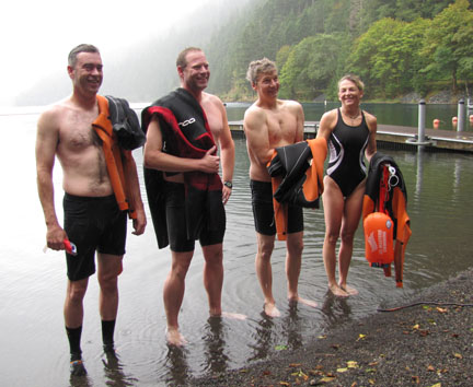 The four swimmers gather for photos after completing their swim along the length of rainy Lake Crescent today. From left are Shawn Delplain