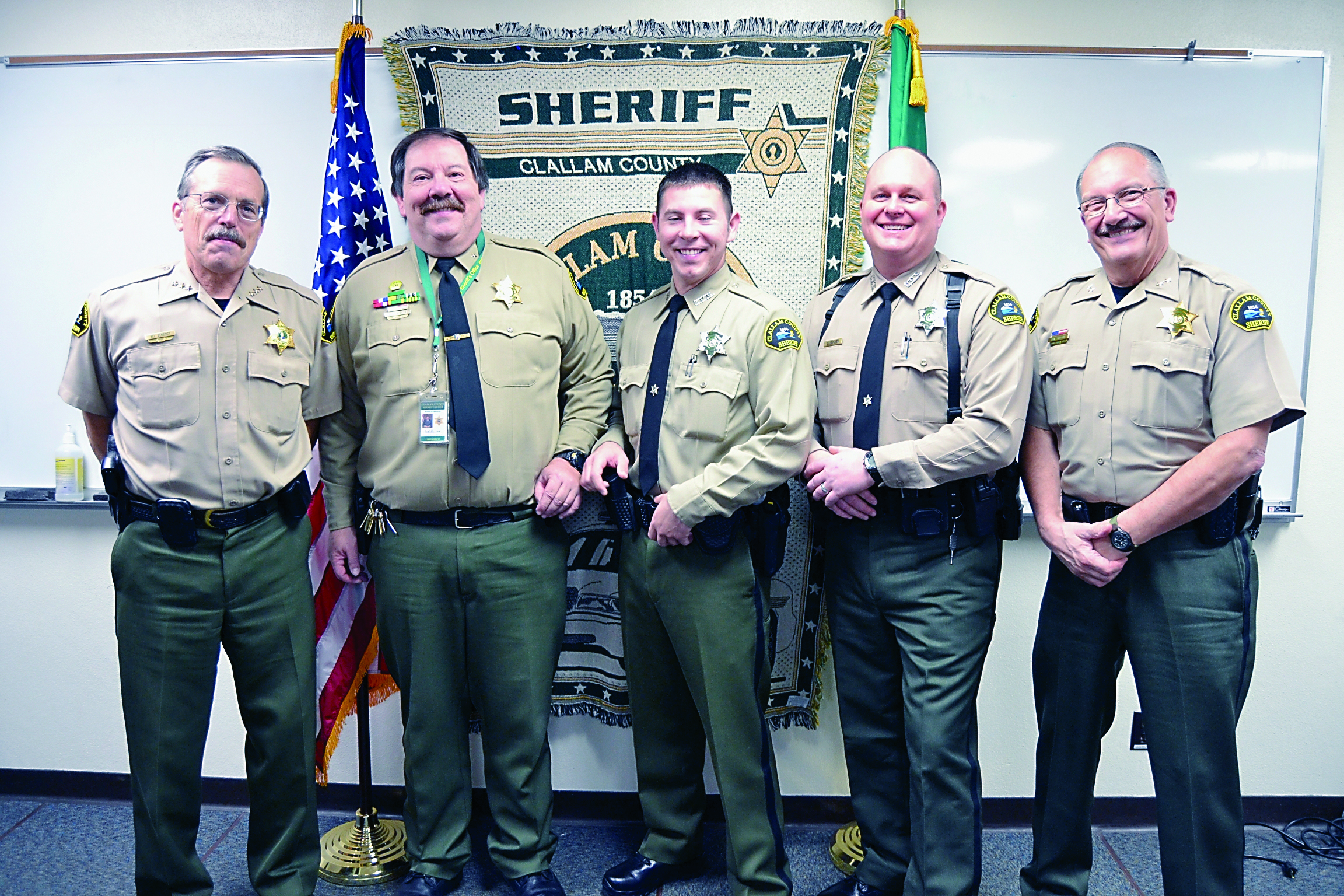 Two new Clallam County Sheriff deputies recently were sworn into service by Sheriff Bill Benedict. From left are Benedict