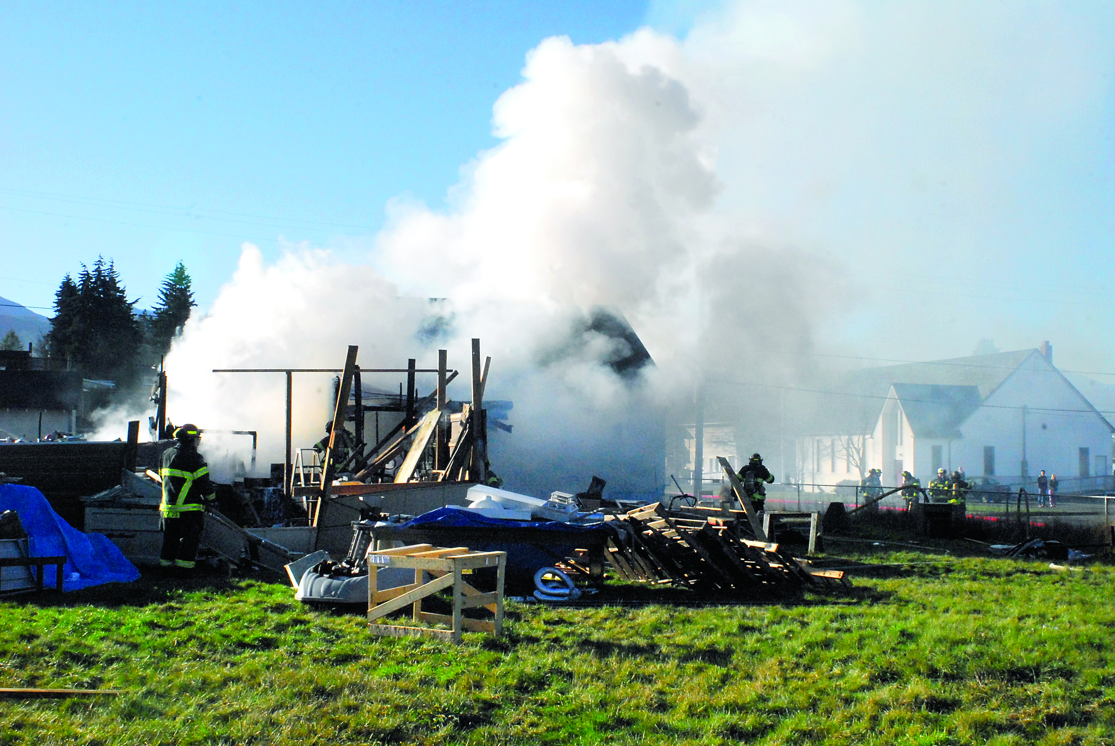 Port Angeles firefighters work to extinguish a fire that consumed a shed in the 213 N. Liberty St. near Georgiana Street in Port Angeles today (Saturday). Keith Thorpe/Peninsula Daily News