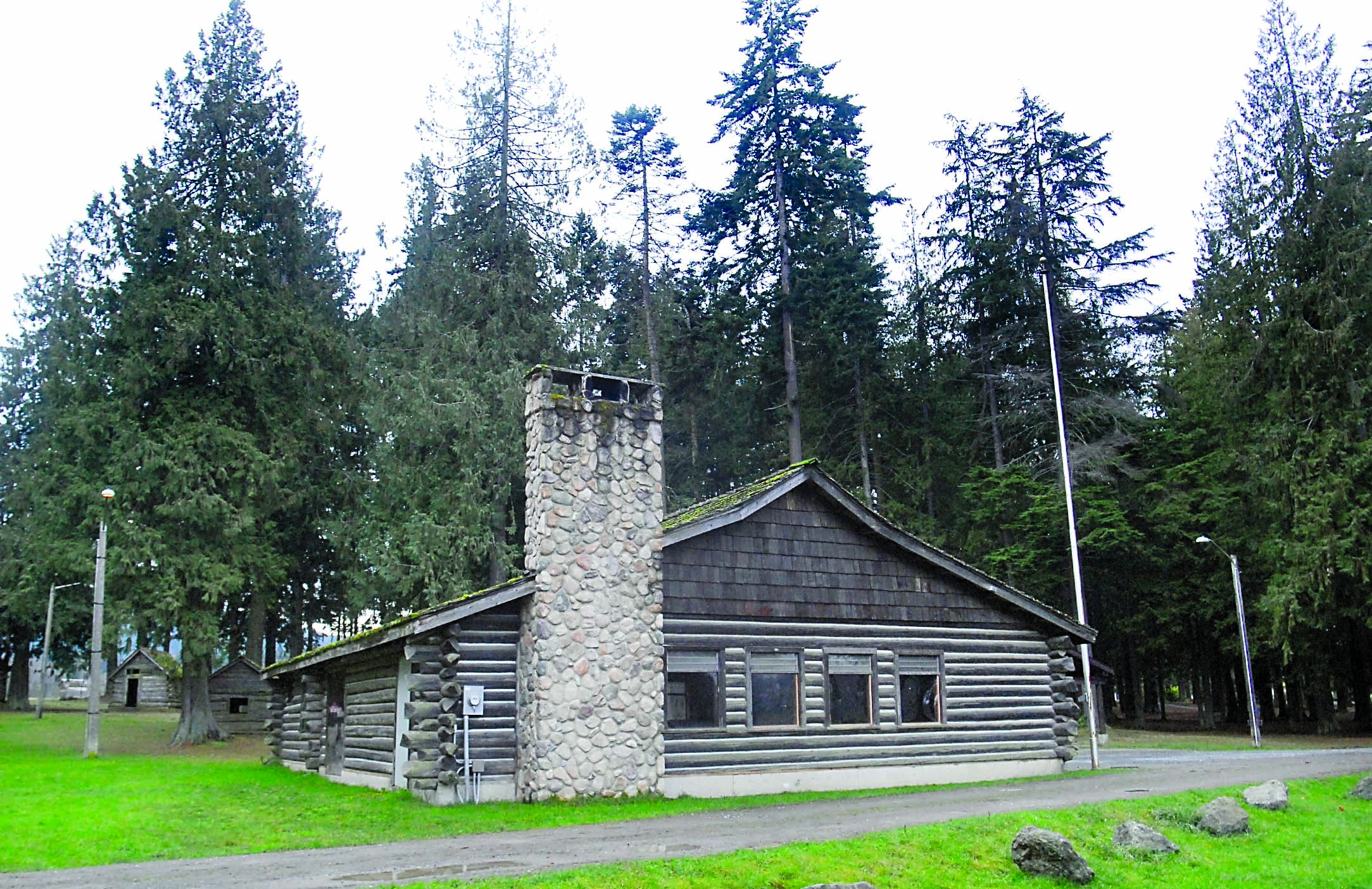 The historic Loomis Tavern building in Port Angeles' Lincoln Park sits next to a stand of trees that PABA members would like to see cut to clear the landing approach for the nearby William R. Fairchild International Airport. Keith Thorpe/Peninsula Daily News