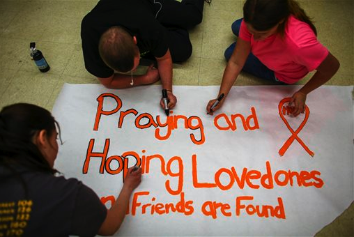 Darrington High School students make posters in the wake of the mudslide. The Associated Press