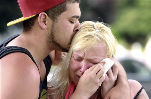 Two students comfort each other as they await word about the safety of students after a shooting at Reynolds High School in Troutdale