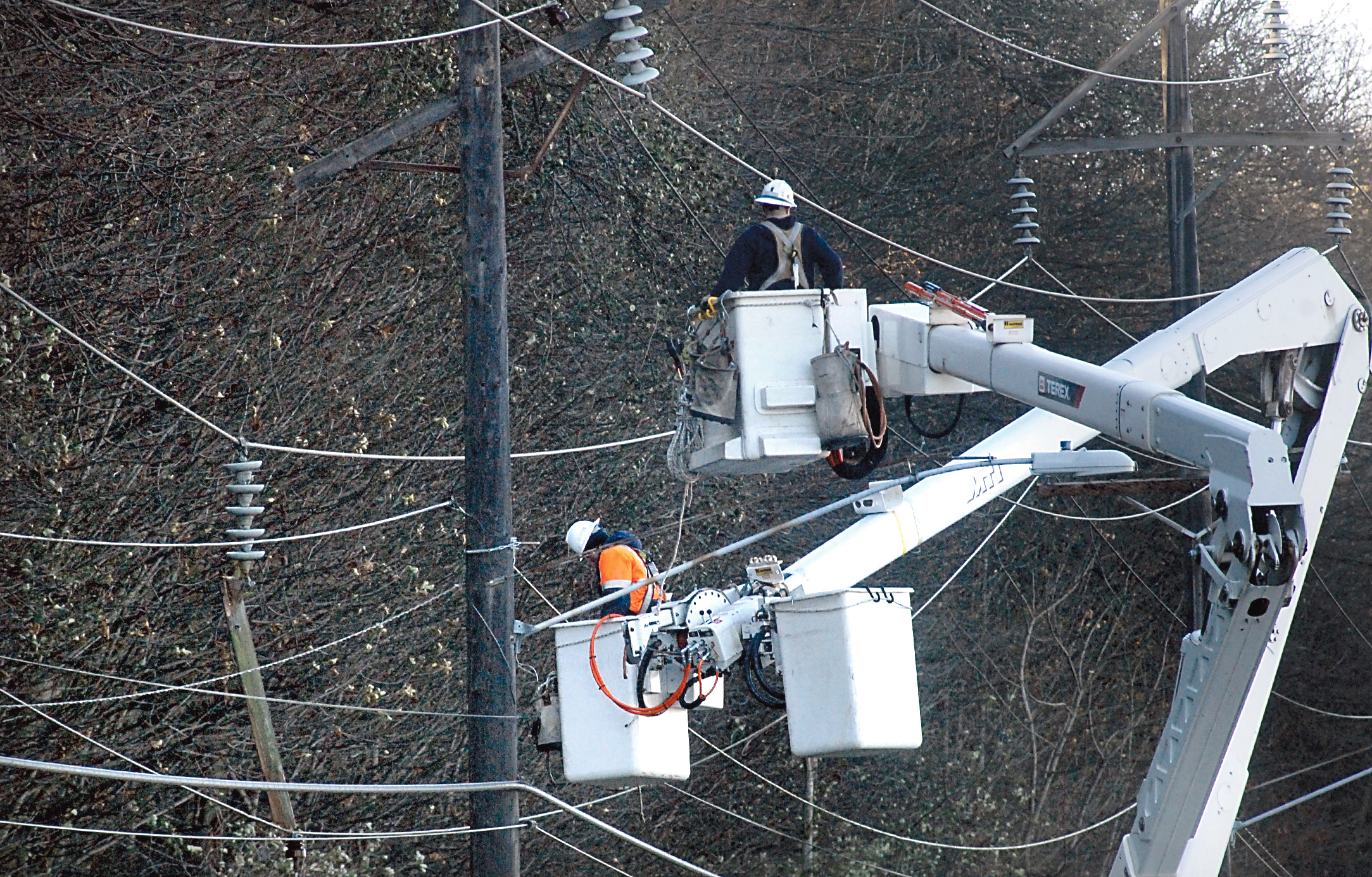 Port Angeles city crews tend to fallen power lines on Marine Drive around noon today. Traffic was being detoured off Marine Drive. Keith Thorpe/Peninsula Daily News