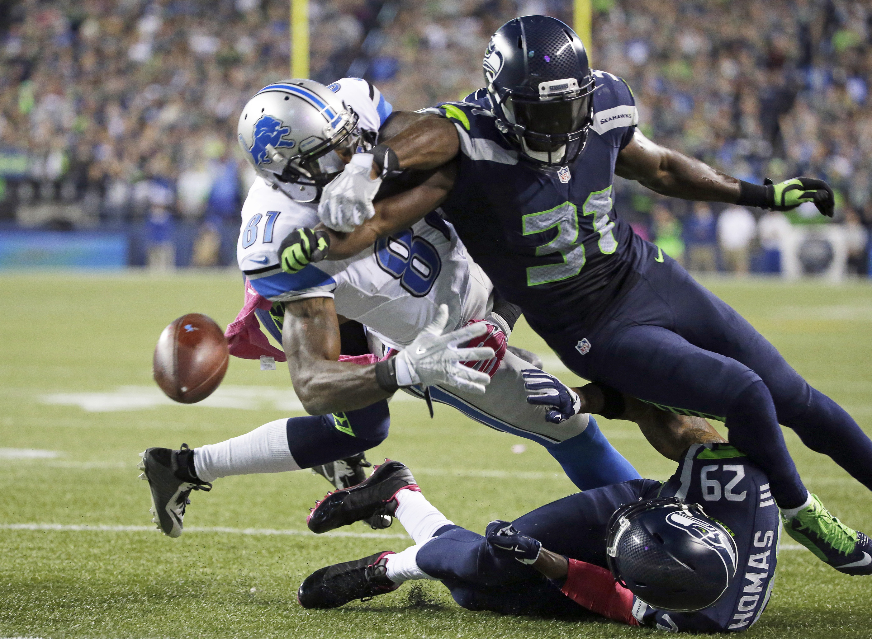 Seattle Seahawks strong safety Kam Chancellor (31) knocks the ball loose from Detroit Lions wide receiver Calvin Johnson (81) in the second half of an NFL football game