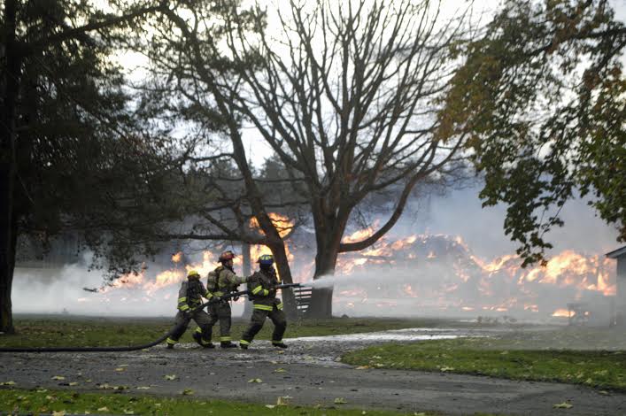 Firefighters battle a barn blaze northeast of Sequim today. Chris McDaniels/Peninsula Daily News