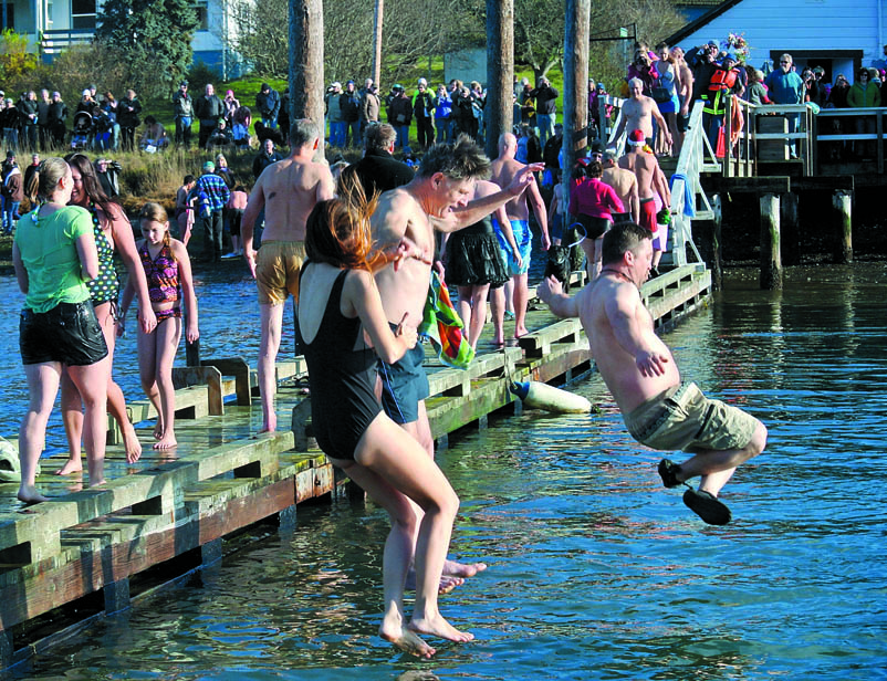 A few of the estimated 120 swimmers jump off the dock near the Nordland General Store Tuesday. Charlie Bermant/Peninsula Daily News