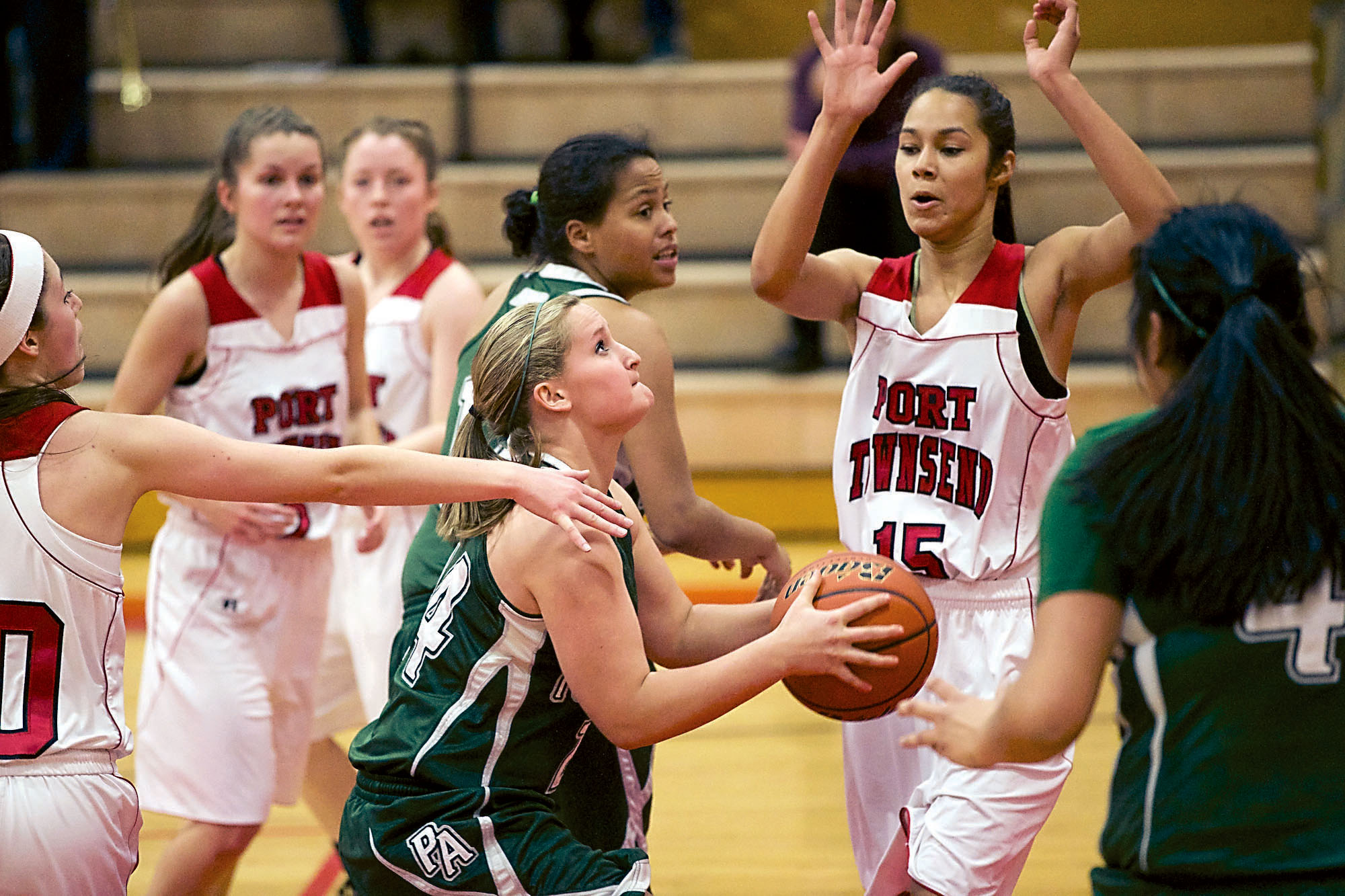 Port Angeles' Hayley Baxley eyes the basket while surrounded by Port Townsend defenders