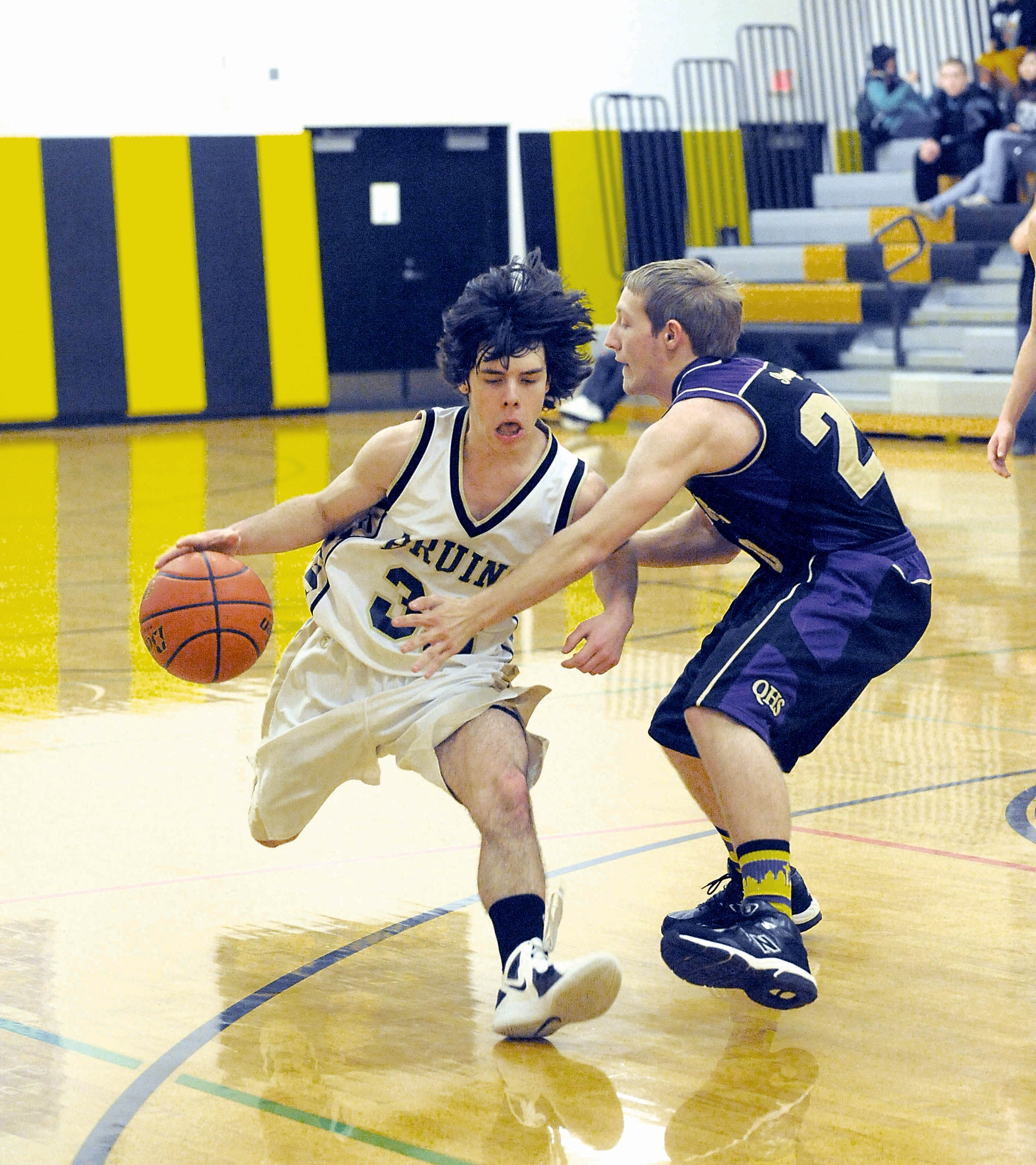 Clallam Bay's Casey Randall (32) drives against Quilcene's Jeremy Van Berkom (20) during the Bruins' 51-47 win over the Rangers. Lonnie Archibald/for Peninsula Daily News