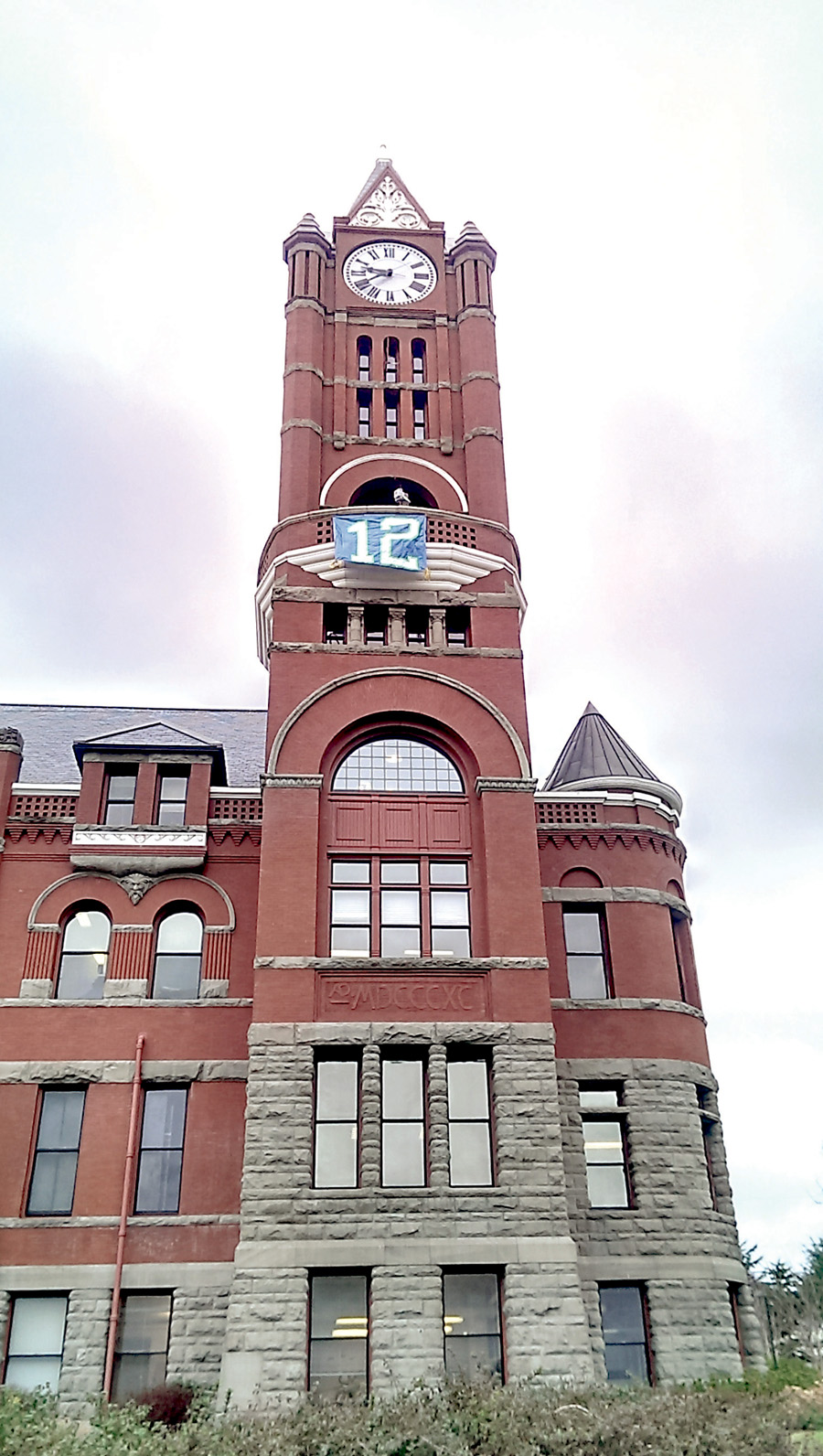 A 12th Man flag flies from the clock tower of the Jefferson County Courthouse in Port Townsend. Luke Bogues