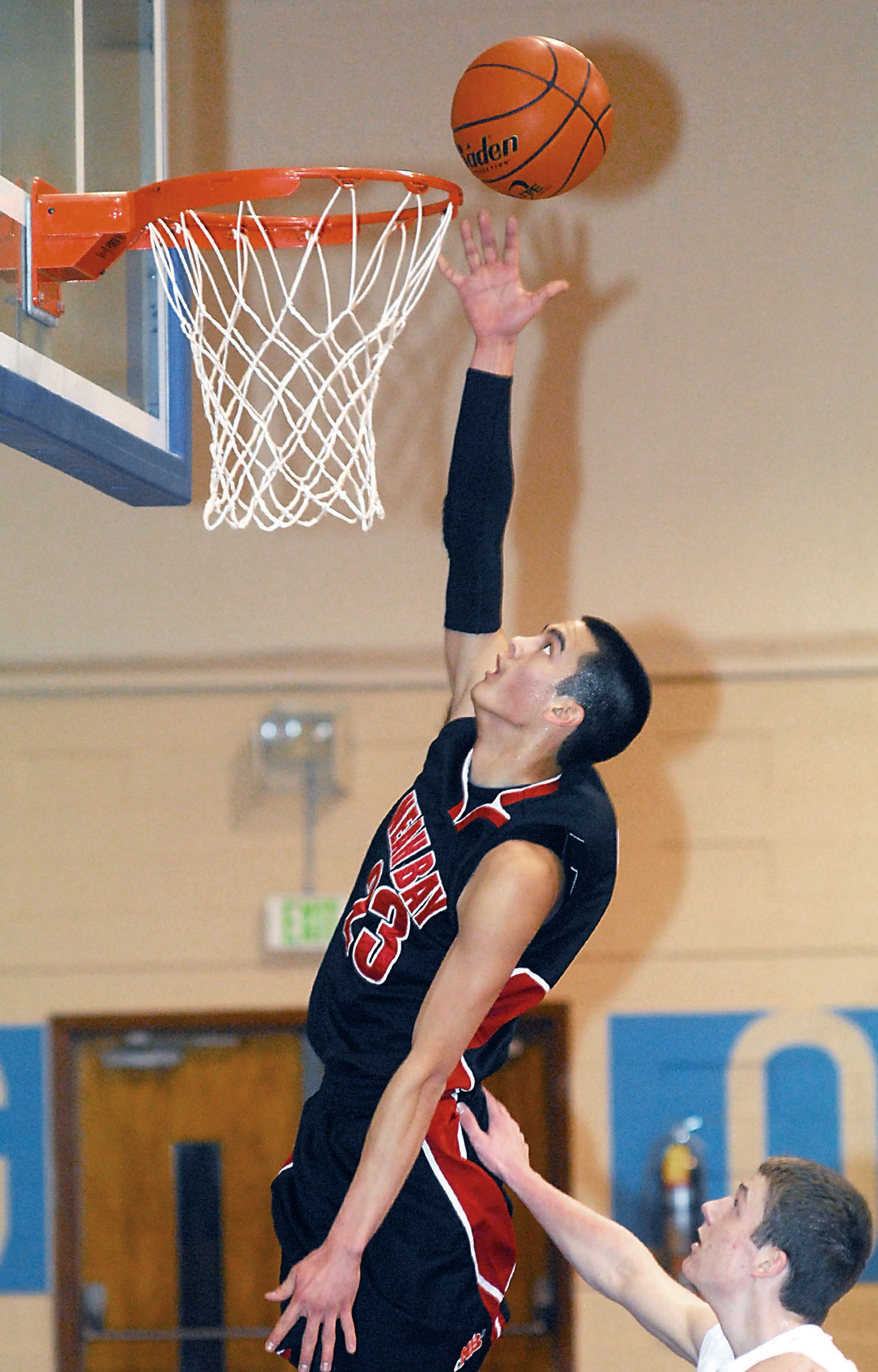 Abraham Venske of Neah Bay makes a breakaway layup as Crescent's Martin Waldrip tries to prevent the score. Keith Thorpe/Peninsula Daily News