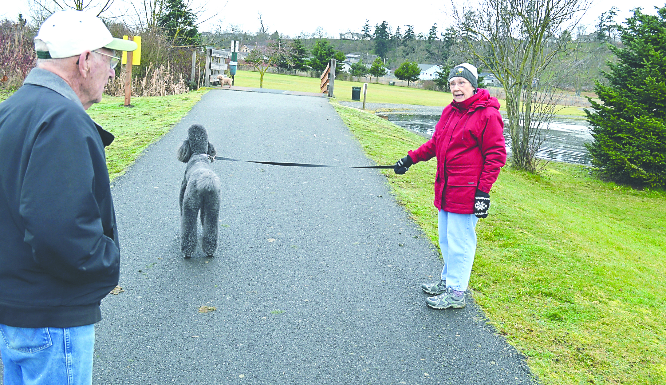 Judy Marshall and Rod Arnold chat during their regular morning dog walk through Sequim's Water Reclamation Park. The city is beginning a project to expand the park. Joe Smillie/Peninsula Daily News