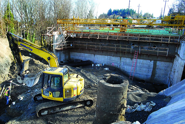 An excavator works at the west side of the new Lauridsen Boulevard bridge over Peabody Creek in Port Angeles on Thursday. Keith Thorpe/Peninsula Daily News