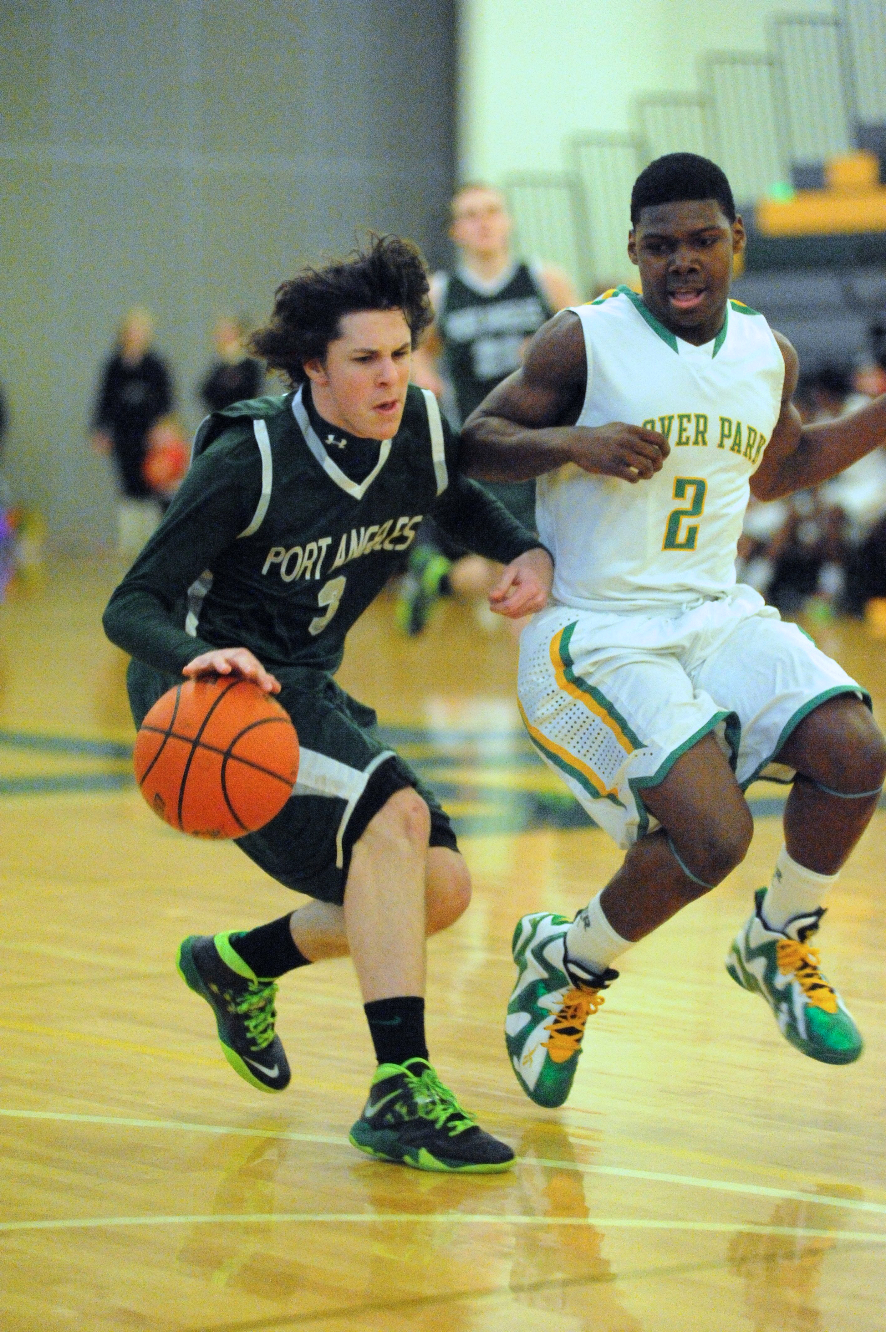 Port Angeles guard Brady Konopaski dribbles upcourt against the defense of Clover Park's Trey Martin. Jeff Halstead/for Peninsula Daily News