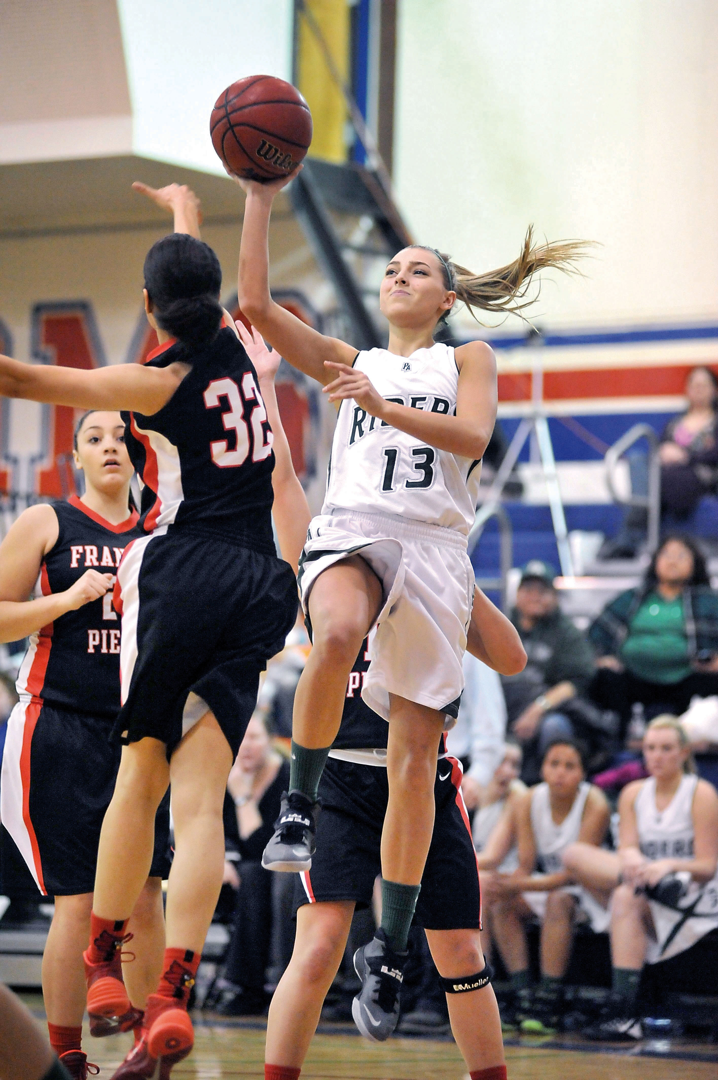 Port Angeles point guard Maddy Hinrichs (13) shoots over the defense of Franklin Pierce's Erica Walker (32) at Wilson High School in Tacoma. Jeff Halstead/for Peninsula Daily News