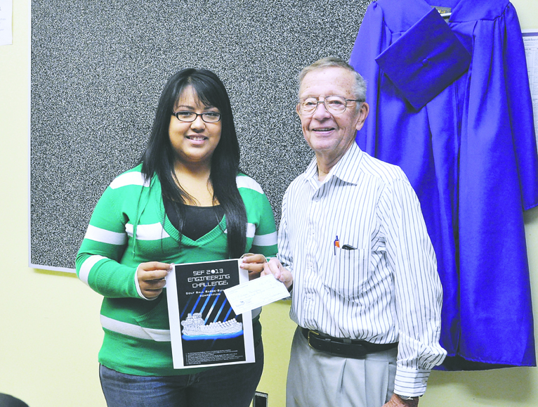 Sequim Education Foundation Engineering Challenge Poster Contest winner Melissa Gonzalez receives a $100 prize last week from SEF Director Walter Johnson. The Engineering Challenge is set to begin at the Sequim Boys & Girls Club at 9 a.m. Saturday.