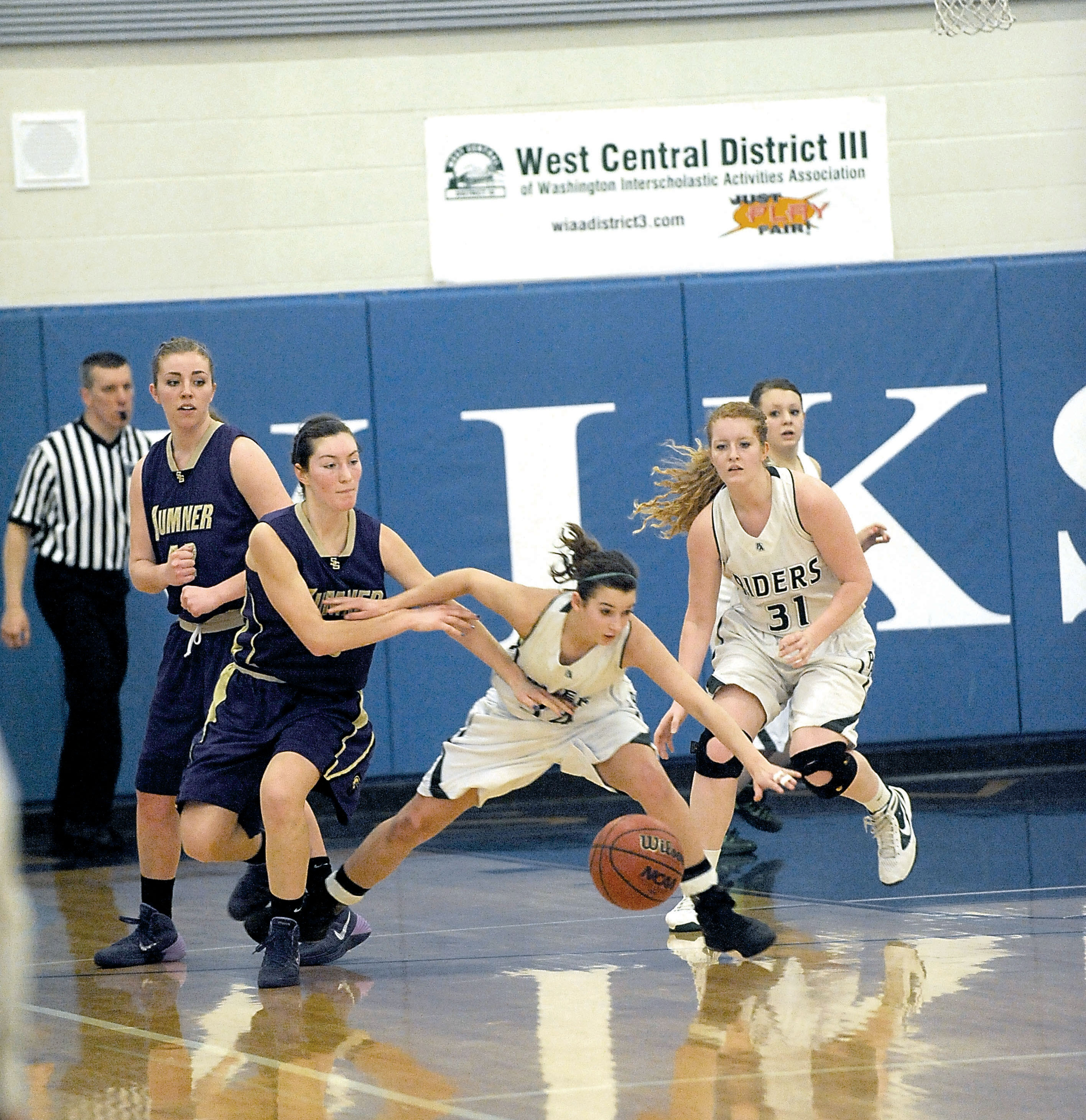 Port Angeles' Kylee Jeffers (34) and Brittany Norberg (31) chase down a loose ball during the Roughriders' loss to Sumner in the West Central District semifinals. Lonnie Archibald/for Peninsula Daily News