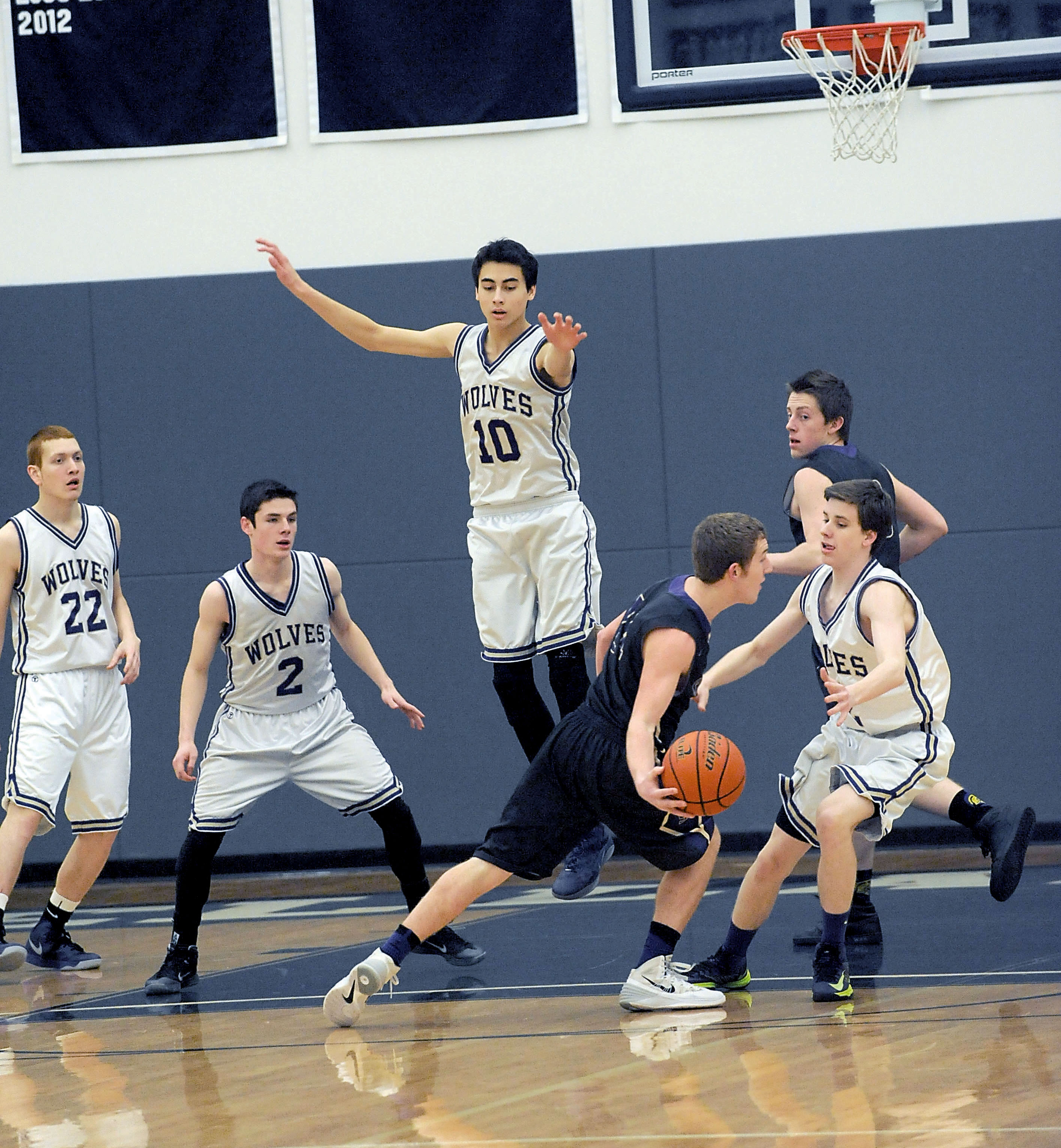 Sequim's Alex Barry (10) takes to the air on defense. Also in on the play for the Wolves are Rory Kallappa (22)