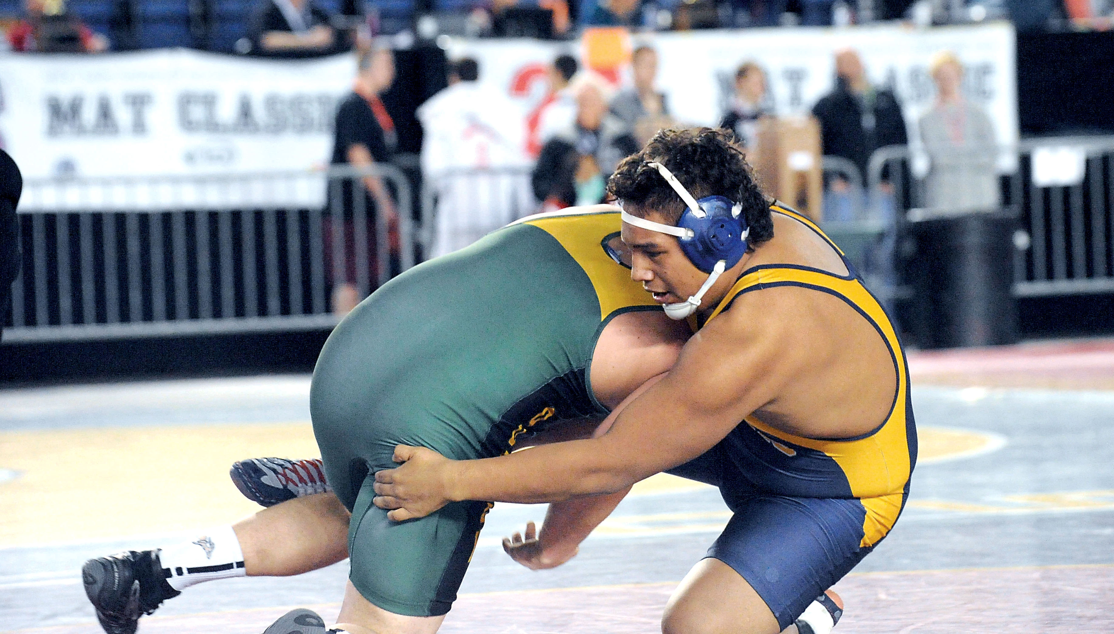 Forks senior Joel Ward wrestles Austin Morris of Quincy in the opening round of the Mat Classic. Ward went on to place second in the Class 1A 220-pound division