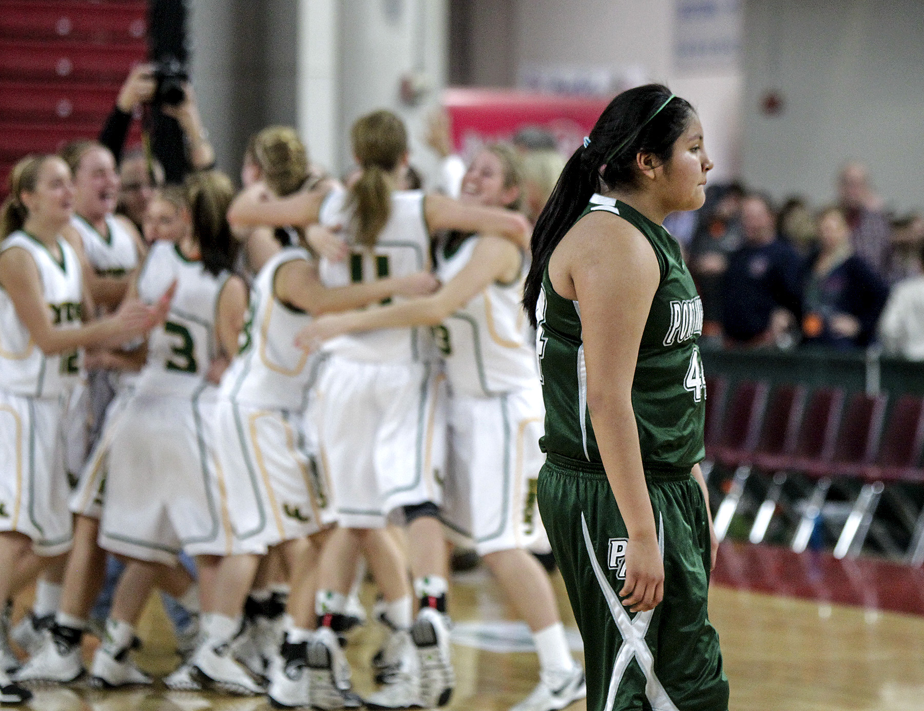 Port Angeles' Nizhoni Wheeler walks quietly off the court while the Lynden team celebrates after Port Angeles' surrendered a game-long lead in the final seconds of their opening round state playoff game. Bill Wagner/The Daily News of Longview