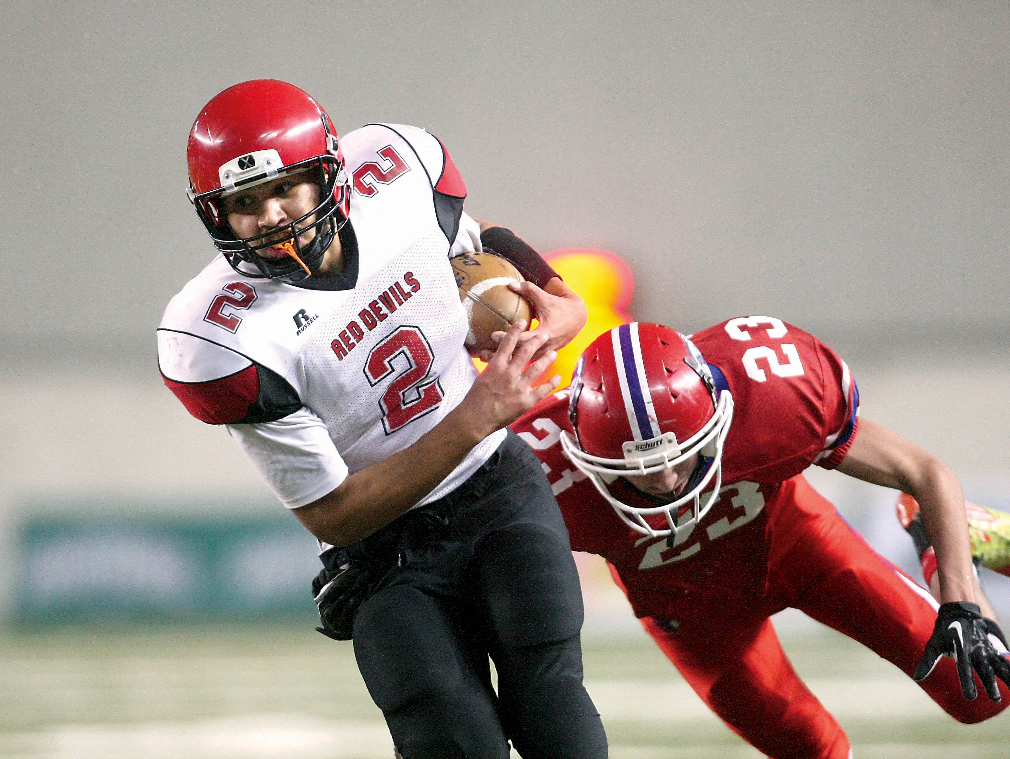 Neah Bay quarterback Josiah Greene (2) runs away from Touchet defender Carlos Rincon (23) during the Red Devils' 36-18 win in the Class 1B state championship game. David Willoughby/for Peninsula Daily News