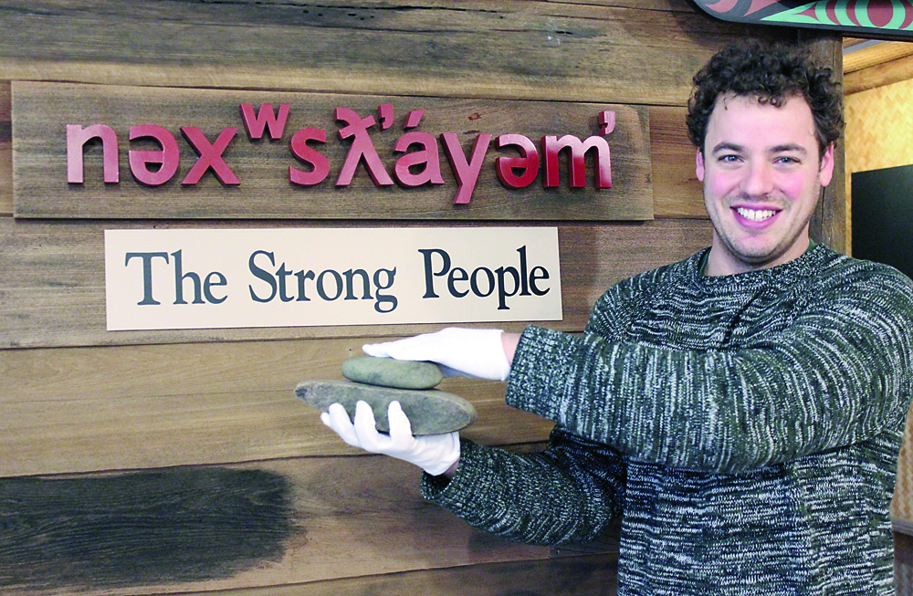 Jamestown S'Klallam Cultural Resources Specialist Gideon Cauffman holds a handstone and grinding slab uncovered during Sequim Bypass excavations in the late 1990s