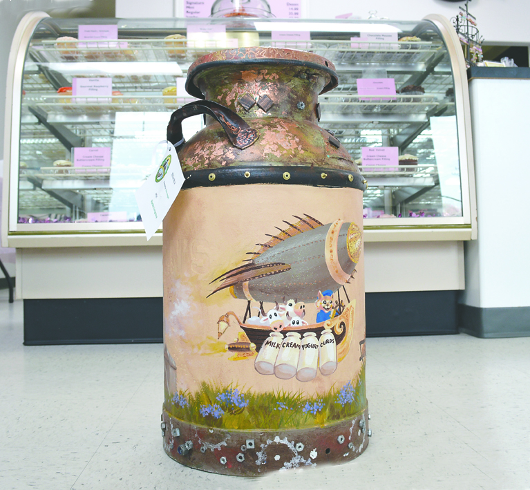 Monika Livingstone's painted milk can sits inside the That Takes the Cake bakery at 171 W. Washington St. in Sequim. Livingstone's can was donated by Kevin Hergert. Historic milk cans have been painted and placed around the city to mark the area's dairy history during its 100th.