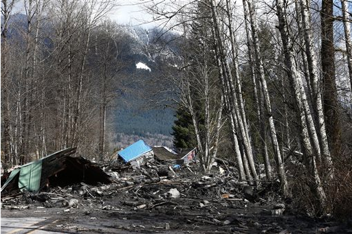 A demolished house sits in the mud on State Highway 530 on Sunday