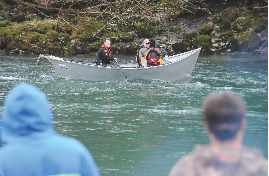 A drift boat makes its way down the Bogachiel River with three of the searchers seeking the missing 79-year-old fisherman. Lonnie Archibald/for Peninsula Daily News