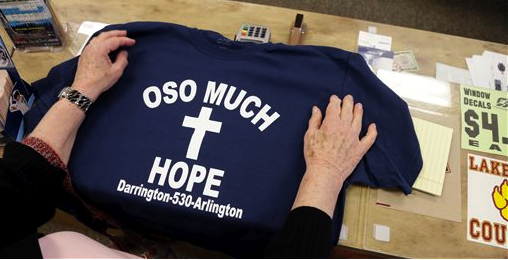 A customer rests her hands on a tee-shirt for sale at an Arlington sporting goods store