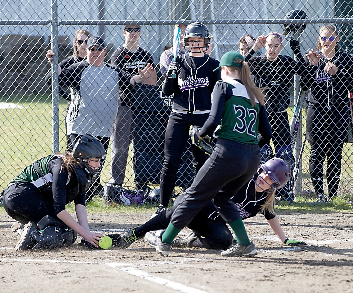 Quilcens's Emily Ward slides into home for a run during against the Evergreen Lutheran Eagles