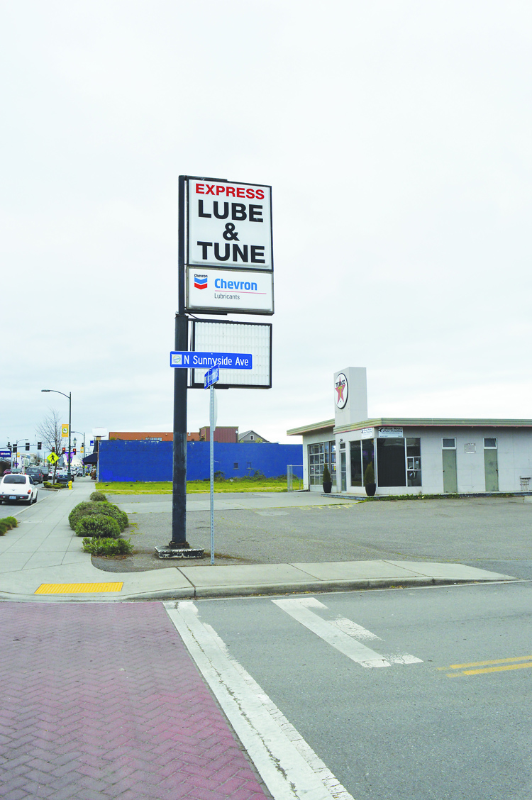 The sign on the corner pole advertises a business that no longer operates at 154 E. Washington St. in Sequim. But city codes won't let Skunk Works Auto Detailing change it. Joe Smillie/Peninsula Daily News