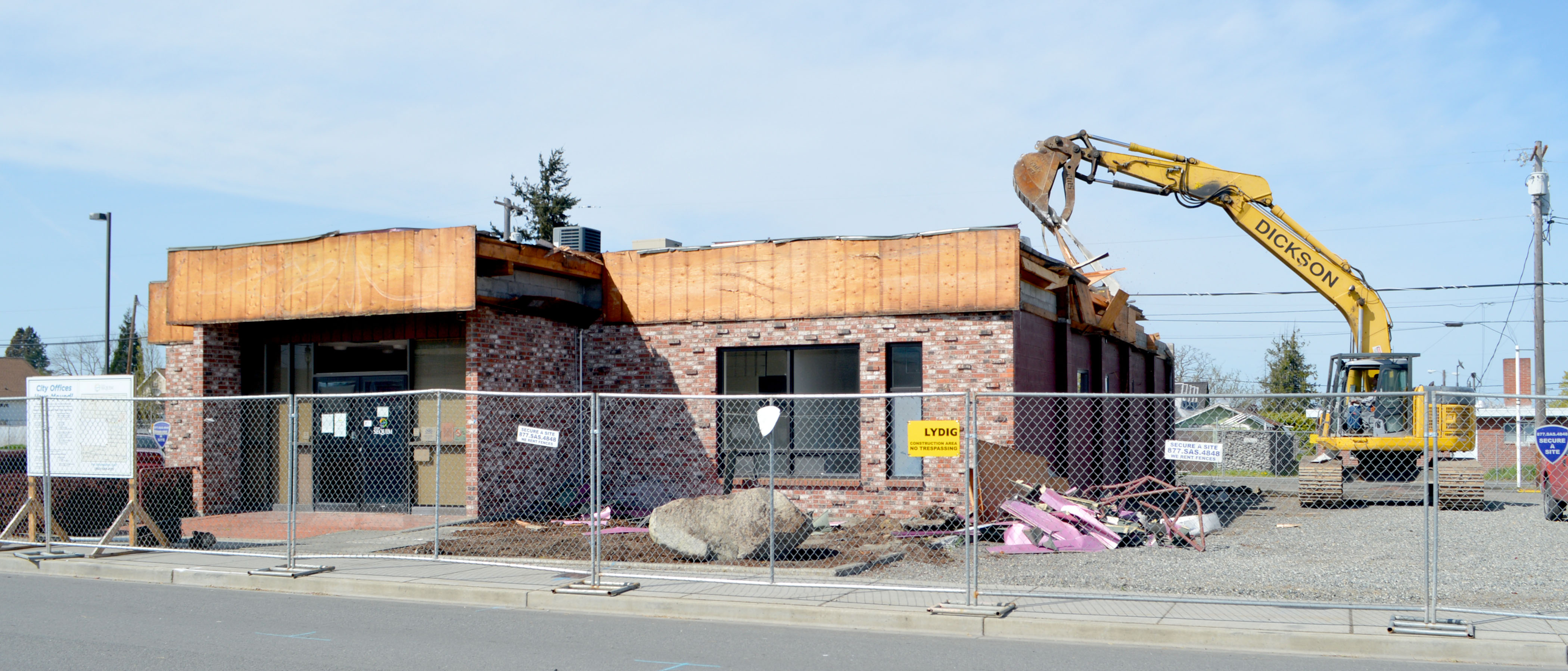 Crews from Tacoma-based Dickson Co. begin razing the old Sequim City Hall on Monday.  —Photo by Joe Smillie/Peninsula Daily News