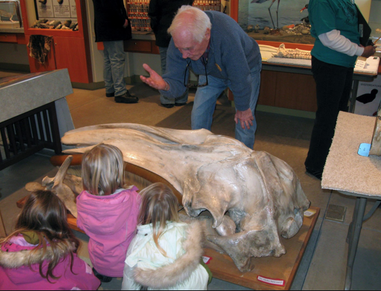 Roger Wilson talks to young students at the Port Townsend Marine Science Center about the skull of a gray whale. Port Townsend Marine Science Center