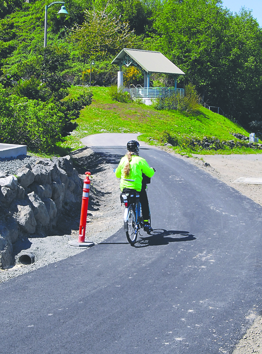 A bicyclist makes her way past Francis Street Park along the reopened Waterfront Trail on Friday in Port Angeles. Keith Thorpe/Peninsula Daily News