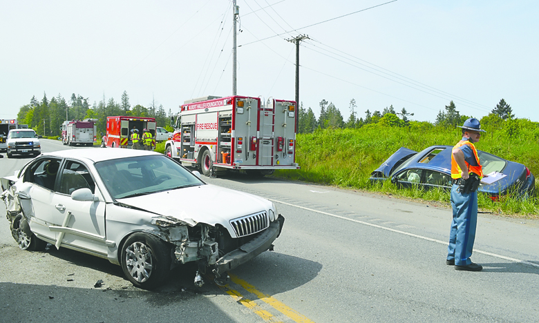 A wreck involving two cars and a semitrailer blocked U.S. Highway 101 for more than an hour at the Barr Road intersection Friday. Joe Smillie/Peninsula Daily News